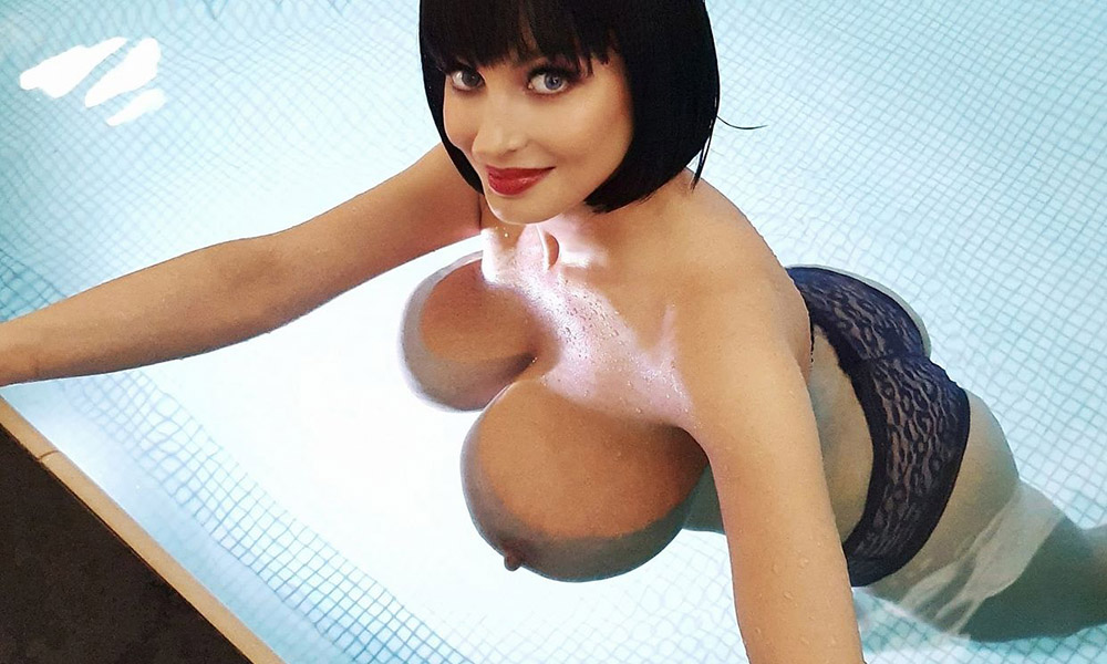 Big boobs floating in the pool